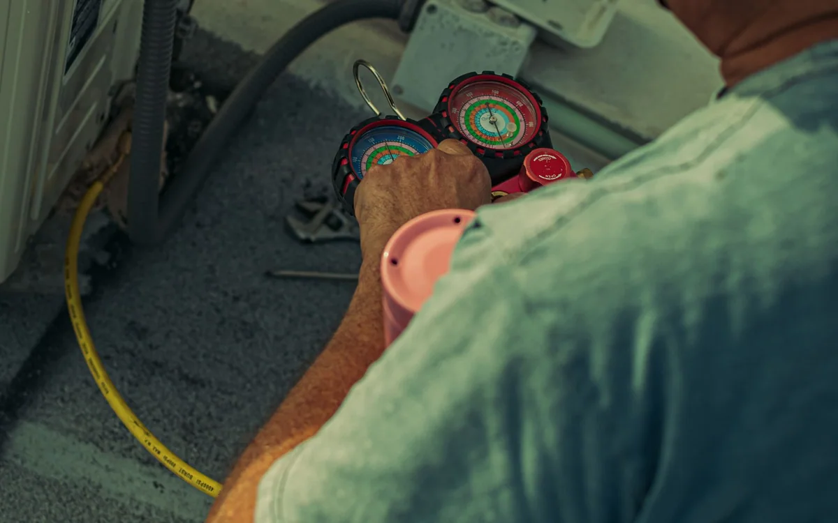 A renter checking thermostat wiring before installing a smart thermostat